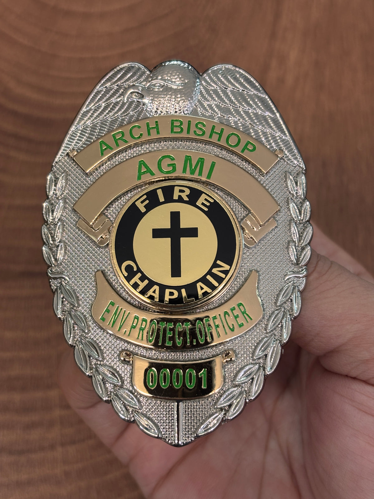 Two-tone custom fire chaplain badge with eagle crest, green lettering, black-and-gold cross emblem, and personalized number 00001