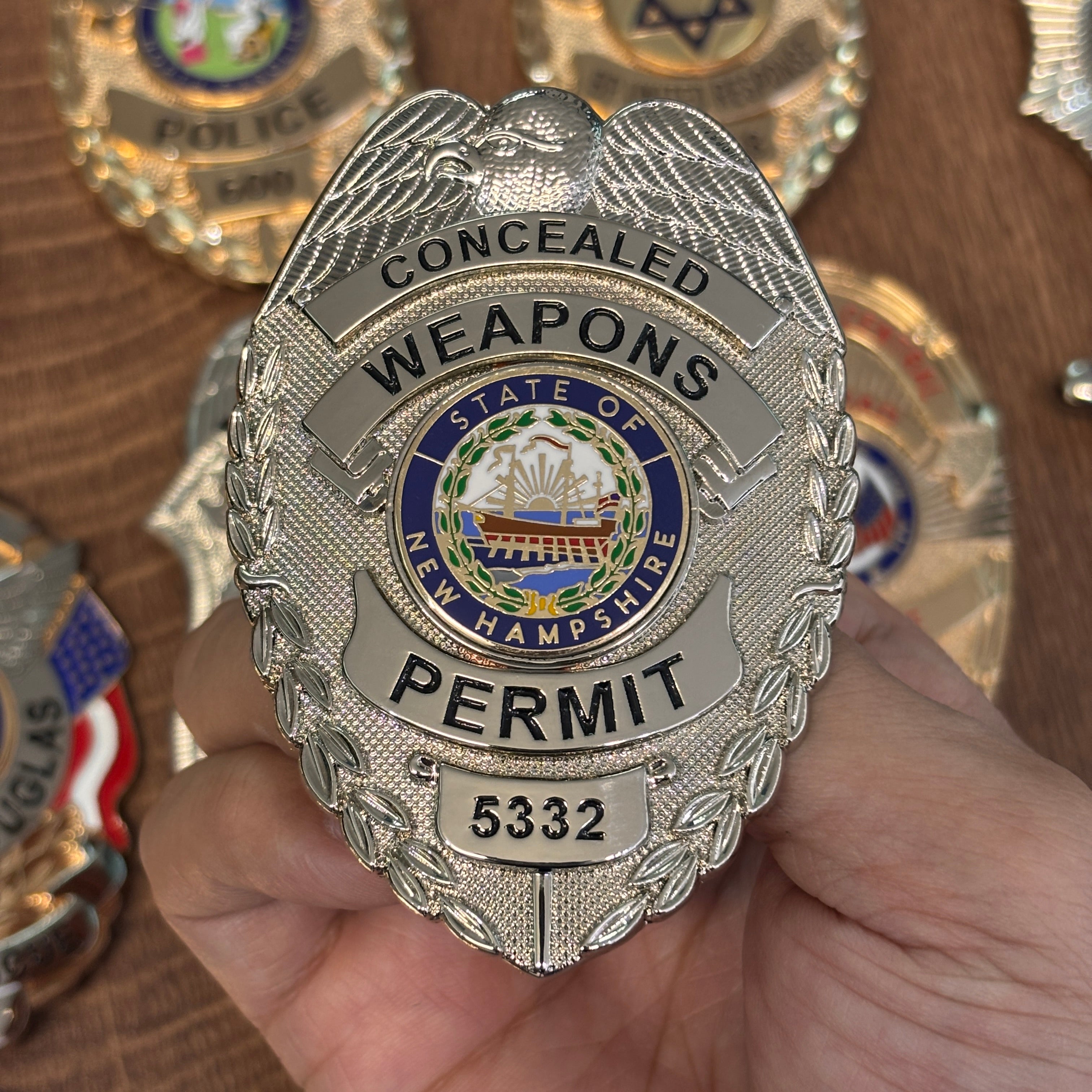Silver-tone personalized permit-style metal badge with eagle crest, New Hampshire center seal, black lettering, and number 5332